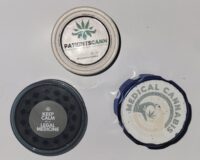 Two closed cannabis grinders
