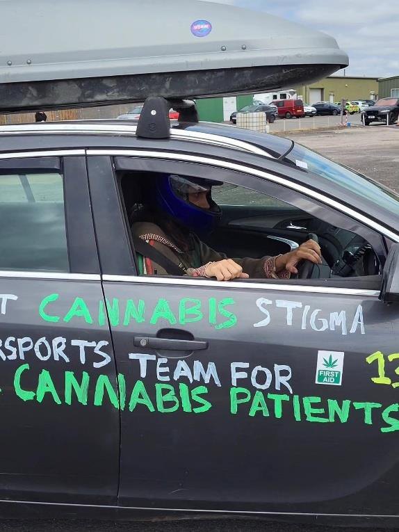 Close-up of the car door livery reading sports team for cannabis patients