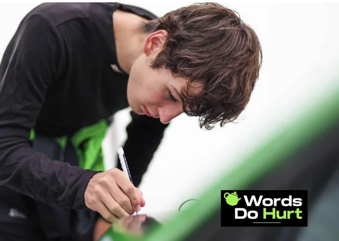 Thomas Potter adding a name to the green Words Do Hurt race car