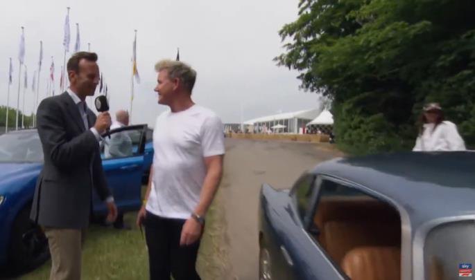 A Sky Sports F1 presenter speaking with Gordon Ramsay in the Goodwood paddock
