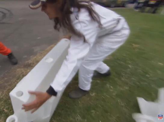 A marshal in white overalls moving a barrier at Goodwood, from Sky Sports F1 coverage